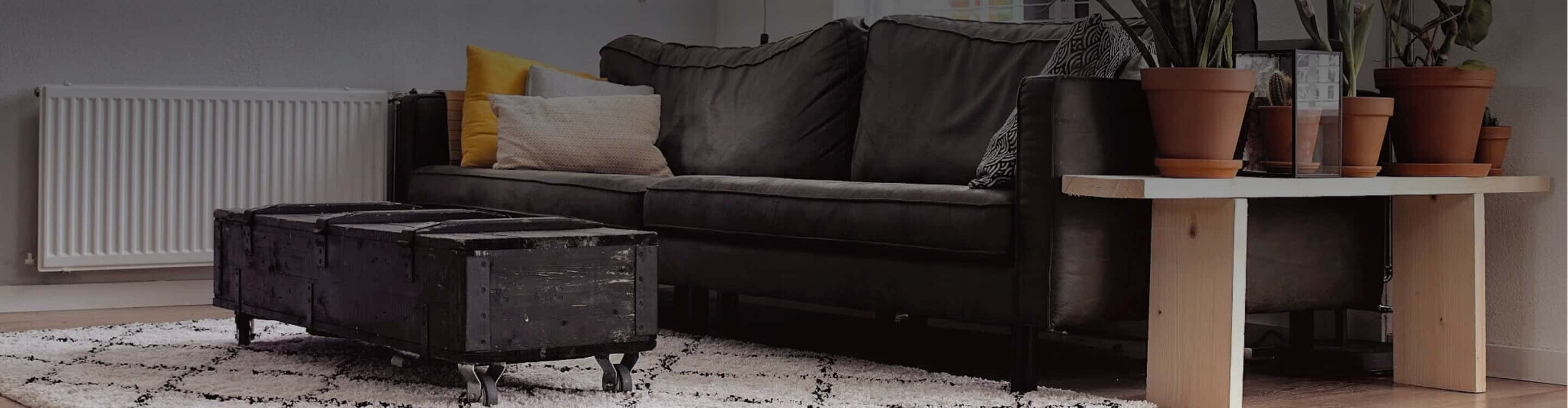 white area rug on vinyl in living room with couch and rustic table